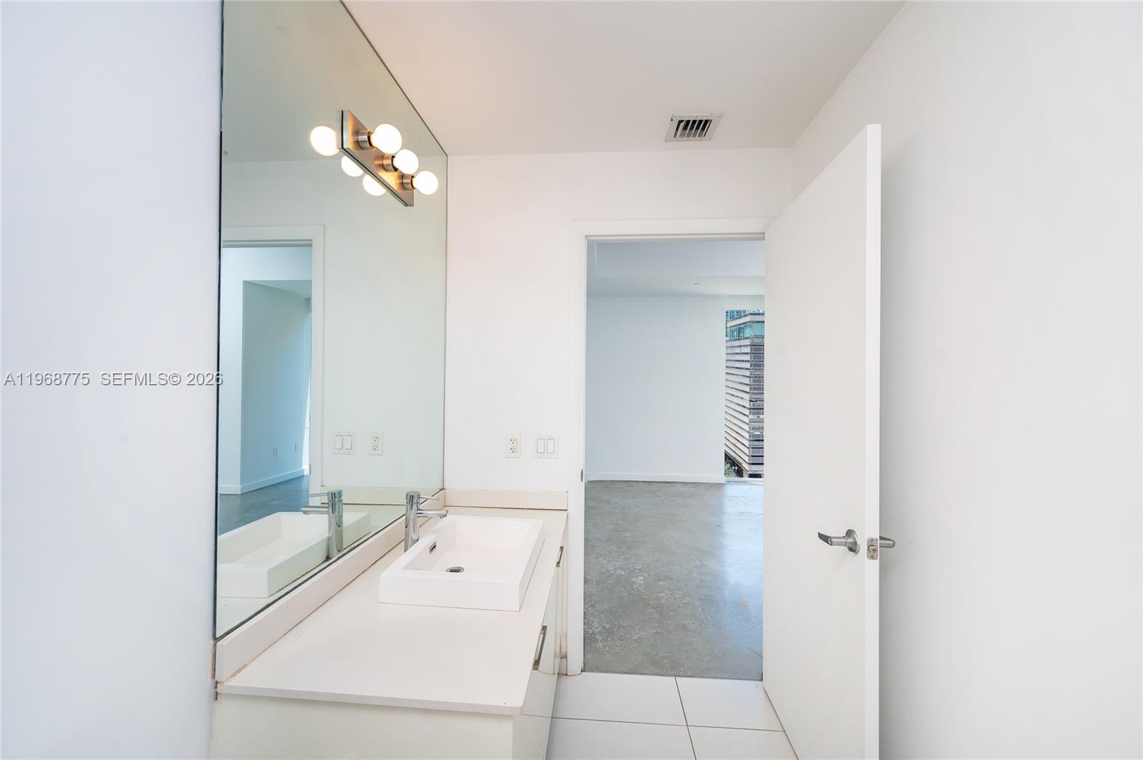151 Southeast 1st Street, Unit 909 Miami, FL 33131 - Photo 11 of 29 a bathroom with a tub shower and a sink
