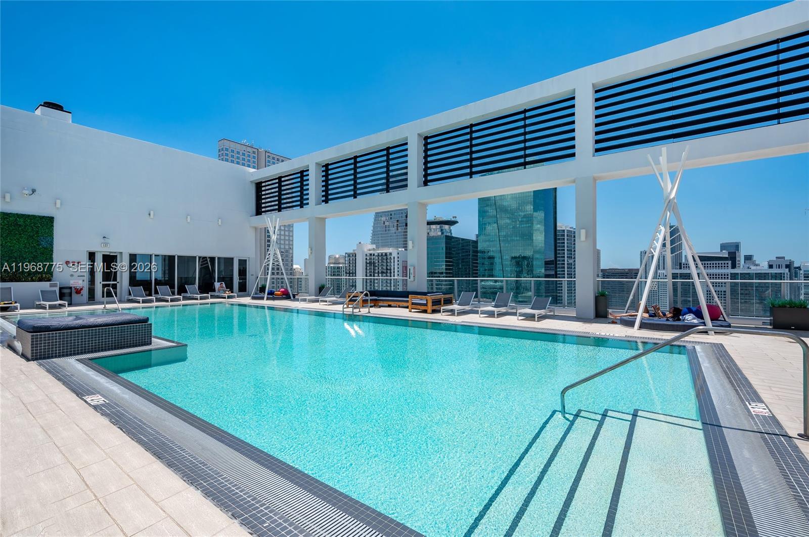 151 Southeast 1st Street, Unit 909 Miami, FL 33131 - Photo 12 of 29 a view of a swimming pool with a patio