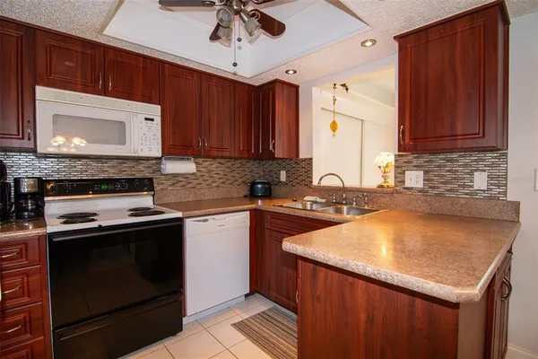a kitchen with a stove sink and cabinets