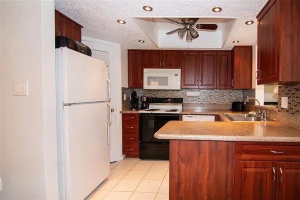 a kitchen with stainless steel appliances a refrigerator sink and cabinets