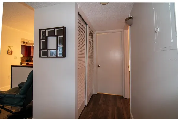 a view of a livingroom with wooden floor and a cabinet