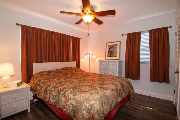 a bed sitting in a bedroom next to a window and a chandelier
