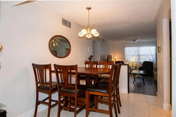 a dining room with furniture a chandelier and a rug