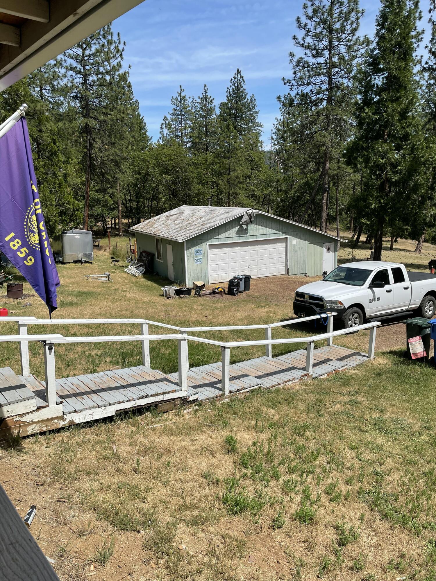 190 Citadel Road Trail, OR 97541 - Photo 8 of 27 a view of a white house with a yard and lawn chairs