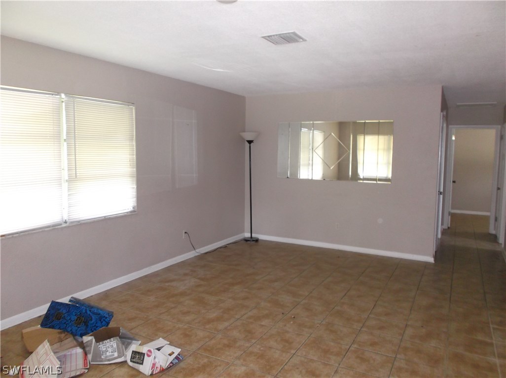 4 Homestead Road South Lehigh Acres, FL 33936 - Photo 2 of 8 an empty room with windows