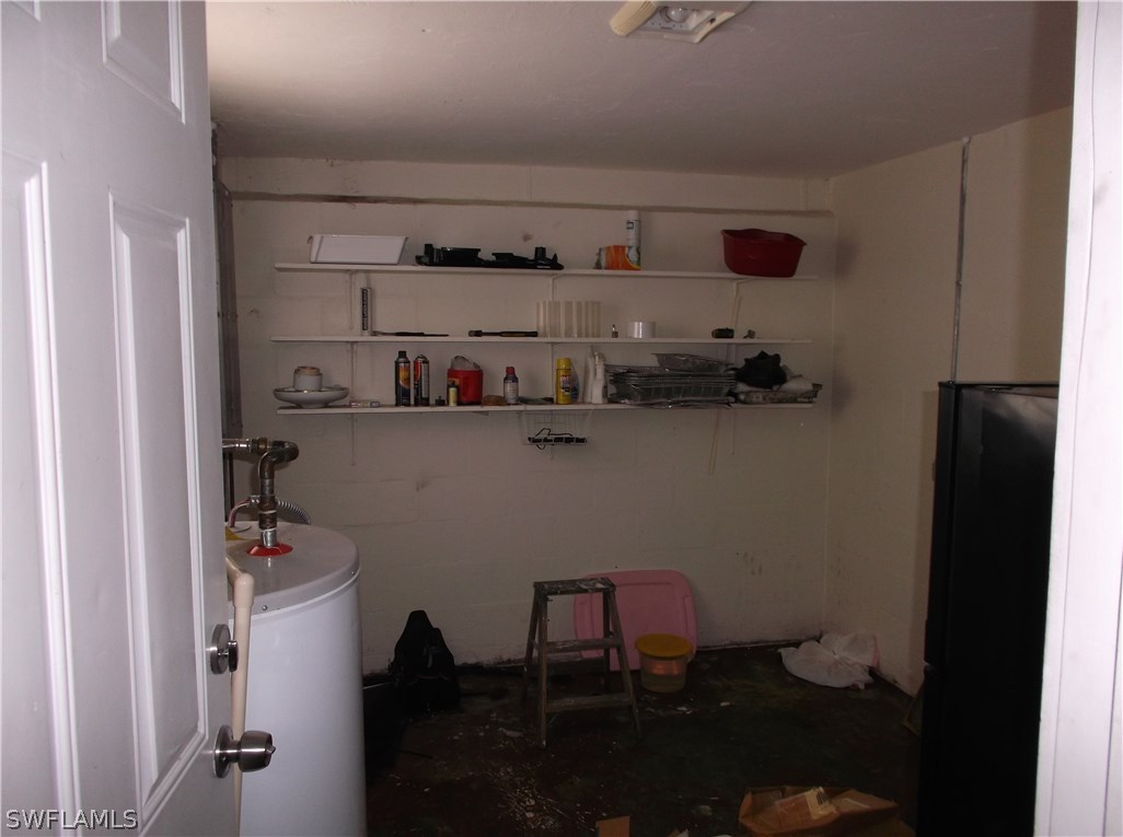 4 Homestead Road South Lehigh Acres, FL 33936 - Photo 8 of 8 a room with a wooden floor and cabinets
