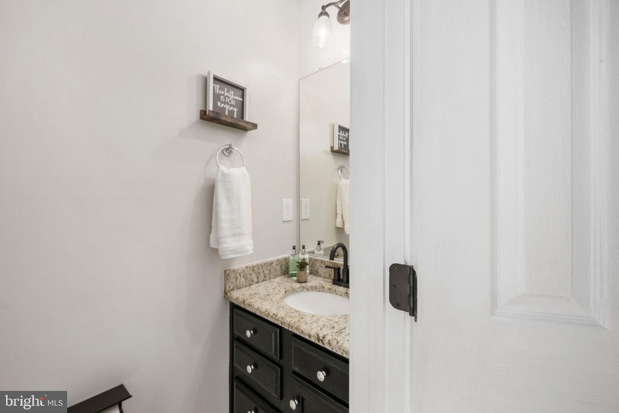 73 Spring Lake Drive Stafford, VA 22556 - Photo 13 of 71 a bathroom with a granite countertop sink and a mirror