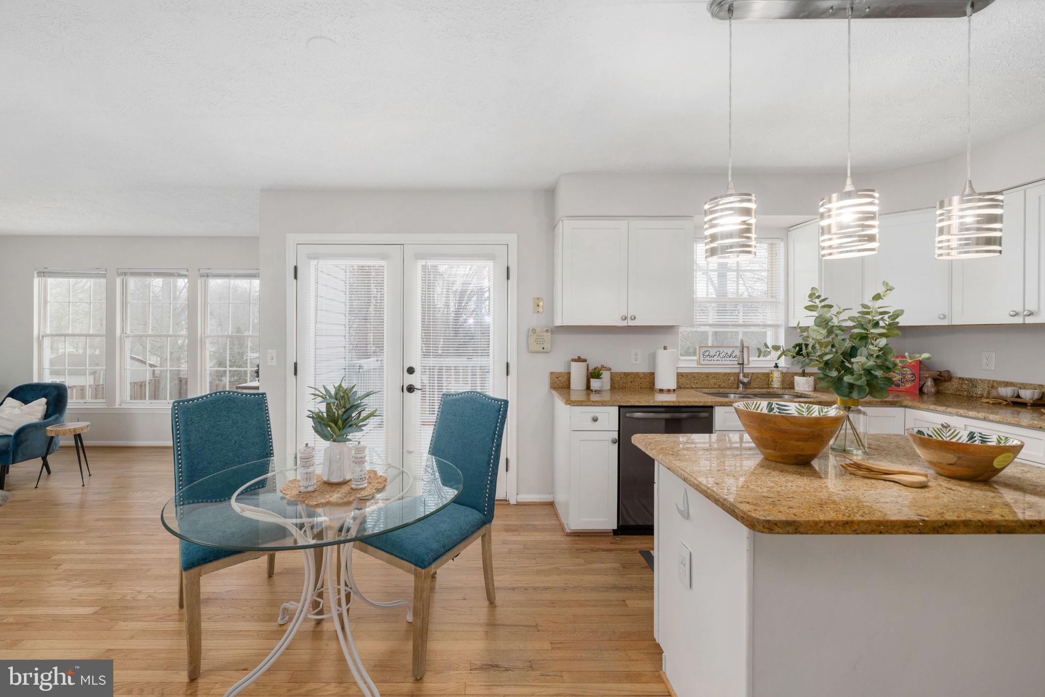 73 Spring Lake Drive Stafford, VA 22556 - Photo 14 of 71 a kitchen with a table chairs and white cabinets