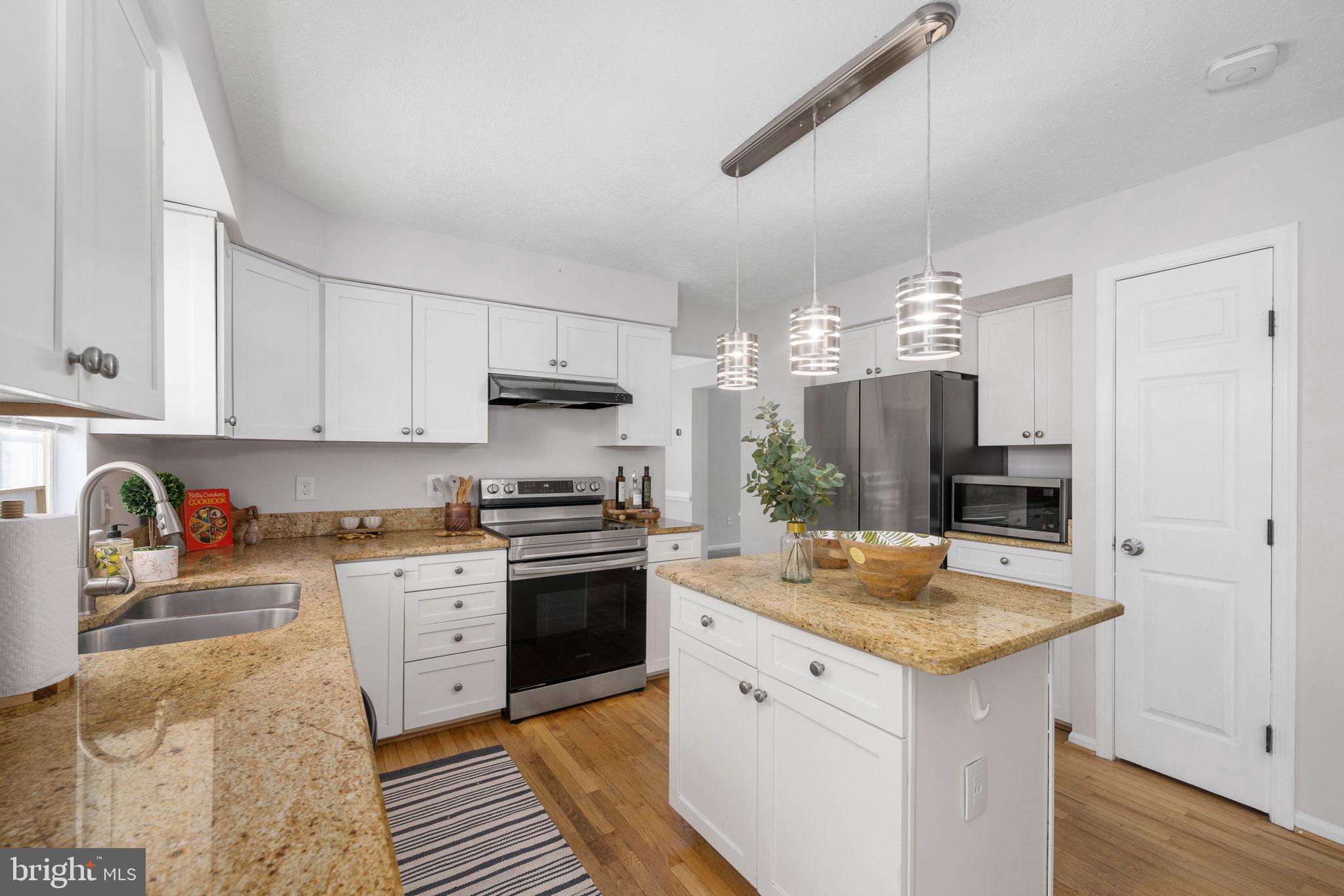 73 Spring Lake Drive Stafford, VA 22556 - Photo 15 of 71 a kitchen with stainless steel appliances granite countertop a sink stove and refrigerator