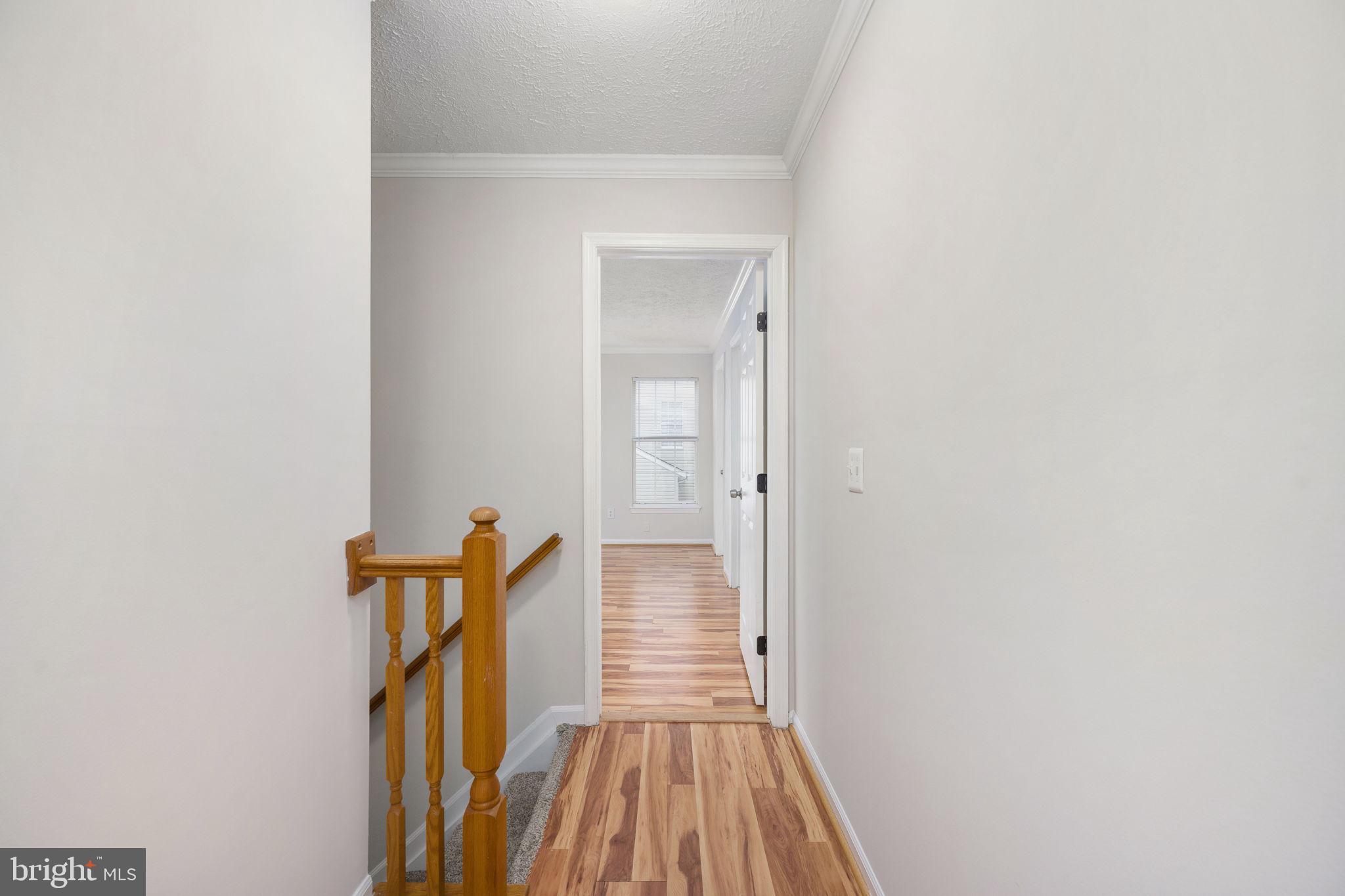 73 Spring Lake Drive Stafford, VA 22556 - Photo 34 of 71 a view of a hallway with wooden floor and staircase