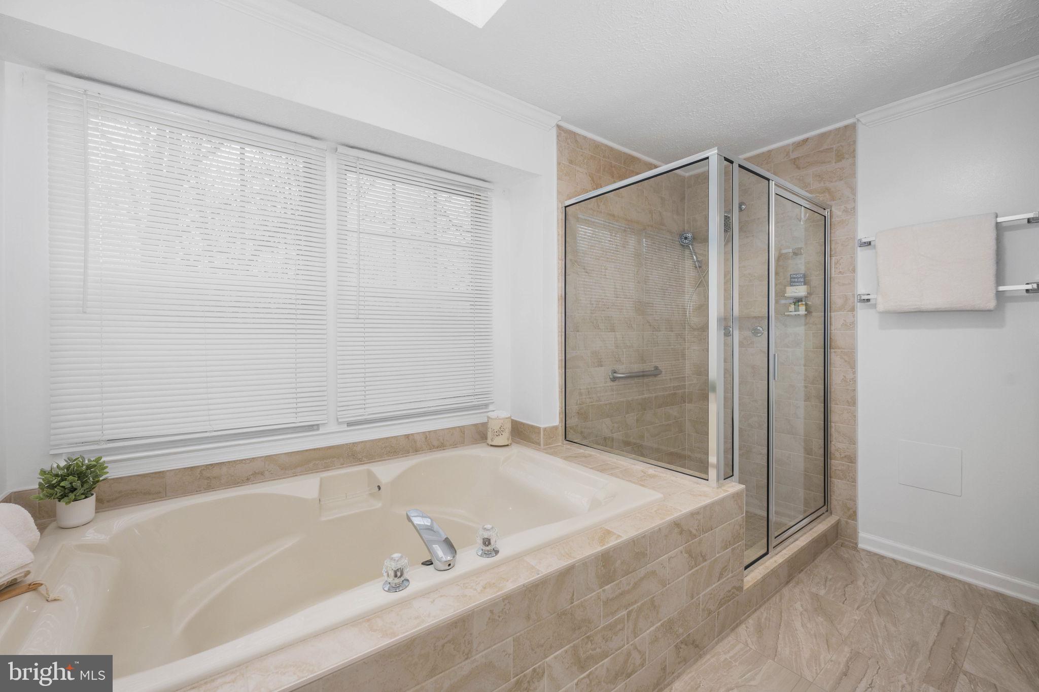 73 Spring Lake Drive Stafford, VA 22556 - Photo 39 of 71 a bathroom with a bathtub and a shower