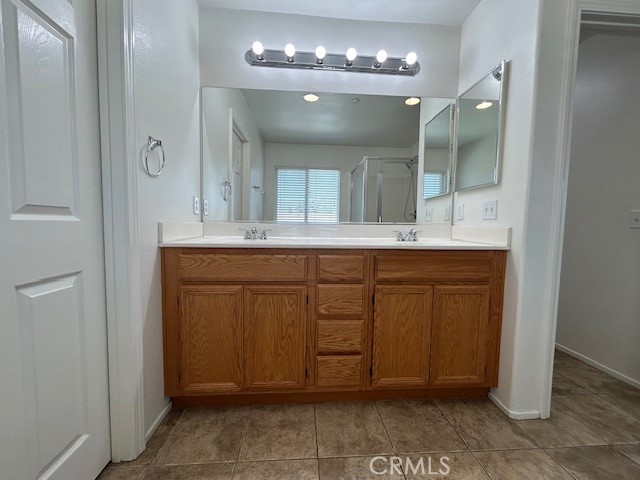 1911 Cefalu Court Riverside, CA 92507 - Photo 14 of 42 a bathroom with a sink and a mirror