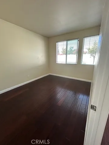 an empty room with wooden floor