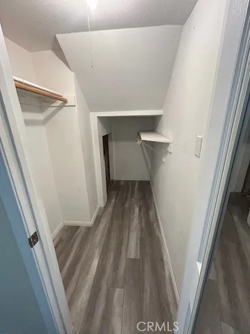 a view of a kitchen with a sink and dishwasher a oven with wooden floor