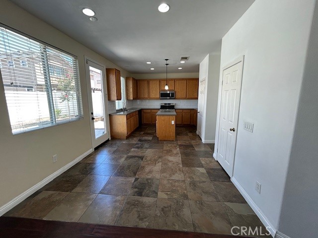 1911 Cefalu Court Riverside, CA 92507 - Photo 25 of 42 a view of a kitchen with a sink and dishwasher a oven with wooden floor
