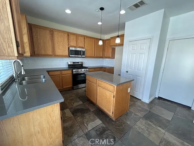 a view of hallway with window and wooden floor