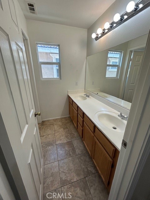 1911 Cefalu Court Riverside, CA 92507 - Photo 41 of 42 a bathroom with a sink a vanity and a mirror
