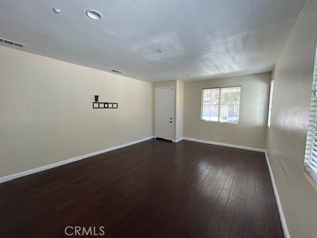 1911 Cefalu Court Riverside, CA 92507 - Photo 9 of 42 an empty room with wooden floor and windows