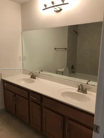 a bathroom with a double vanity sink a and mirror