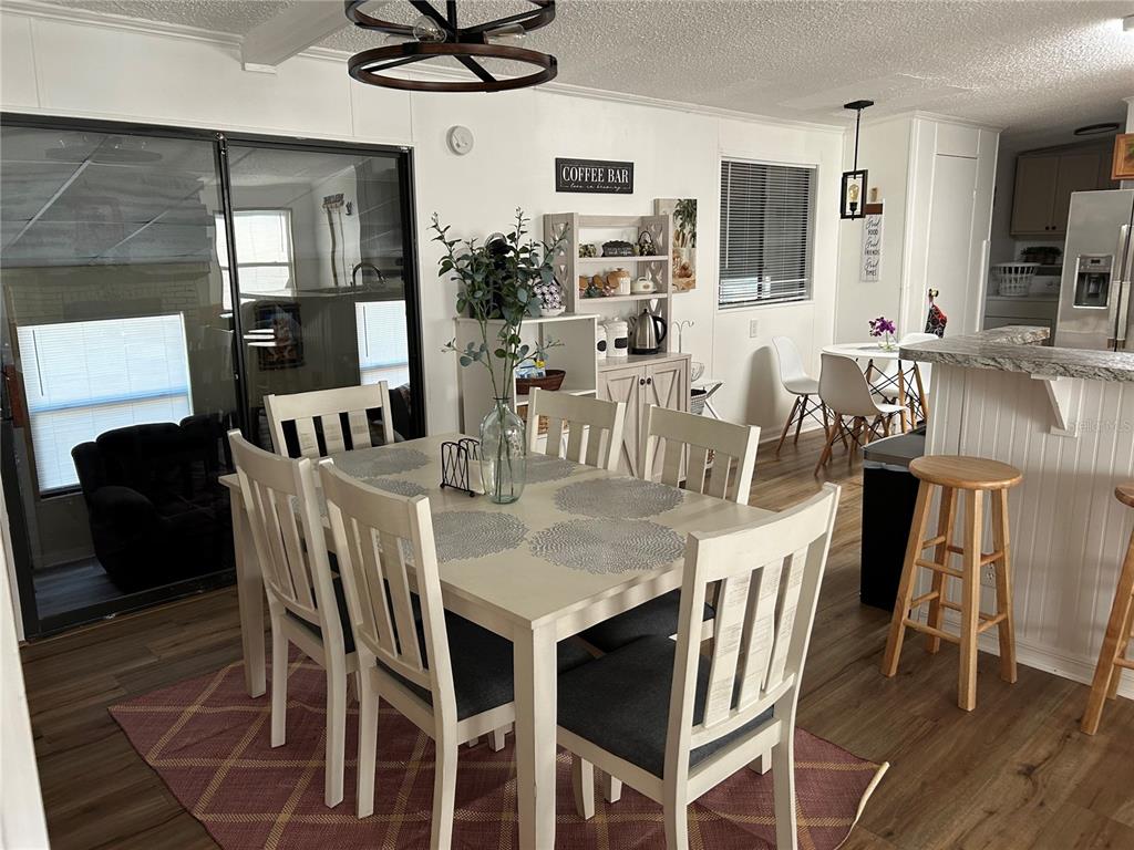 55624 Sam Street Astor, FL 32102 - Photo 12 of 12 a view of a dining room with furniture and wooden floor