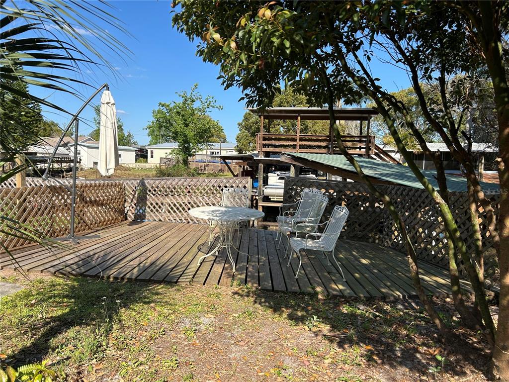 55624 Sam Street Astor, FL 32102 - Photo 2 of 12 a view of balcony with chairs and potted plants