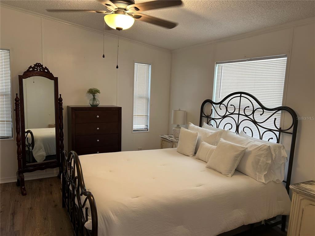 55624 Sam Street Astor, FL 32102 - Photo 6 of 12 a bedroom with a bed and a chandelier
