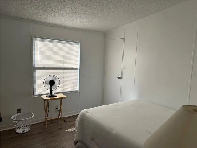 a bedroom with a bed and a table