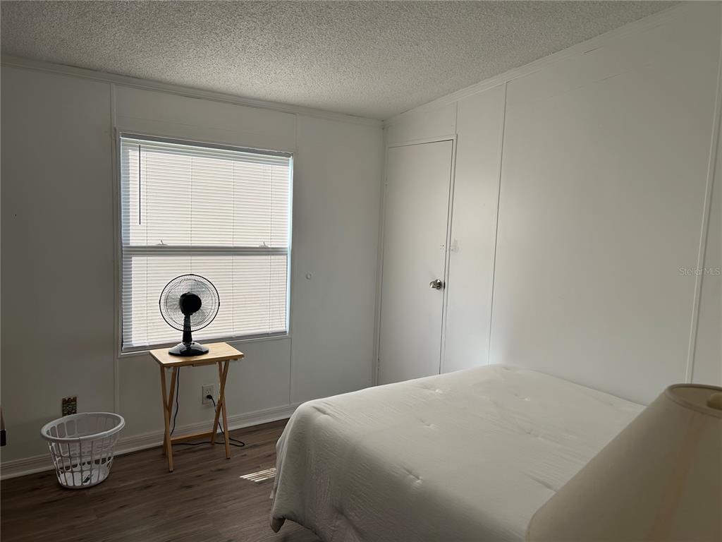 55624 Sam Street Astor, FL 32102 - Photo 8 of 12 a bedroom with a bed and a table