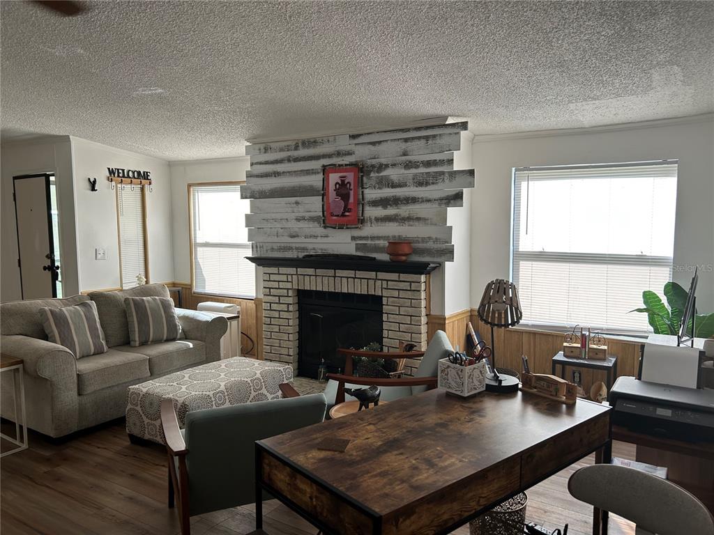 55624 Sam Street Astor, FL 32102 - Photo 10 of 12 a living room with furniture and a fireplace