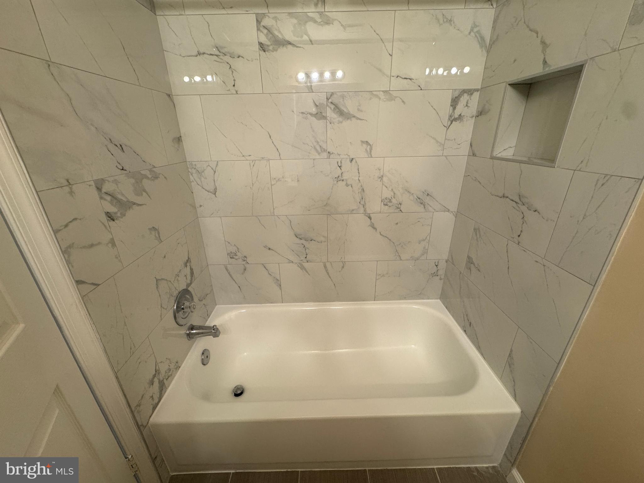 11263 Raging Brook Drive, Unit 253 Bowie, MD 20720 - Photo 20 of 22 a bathroom with a tub