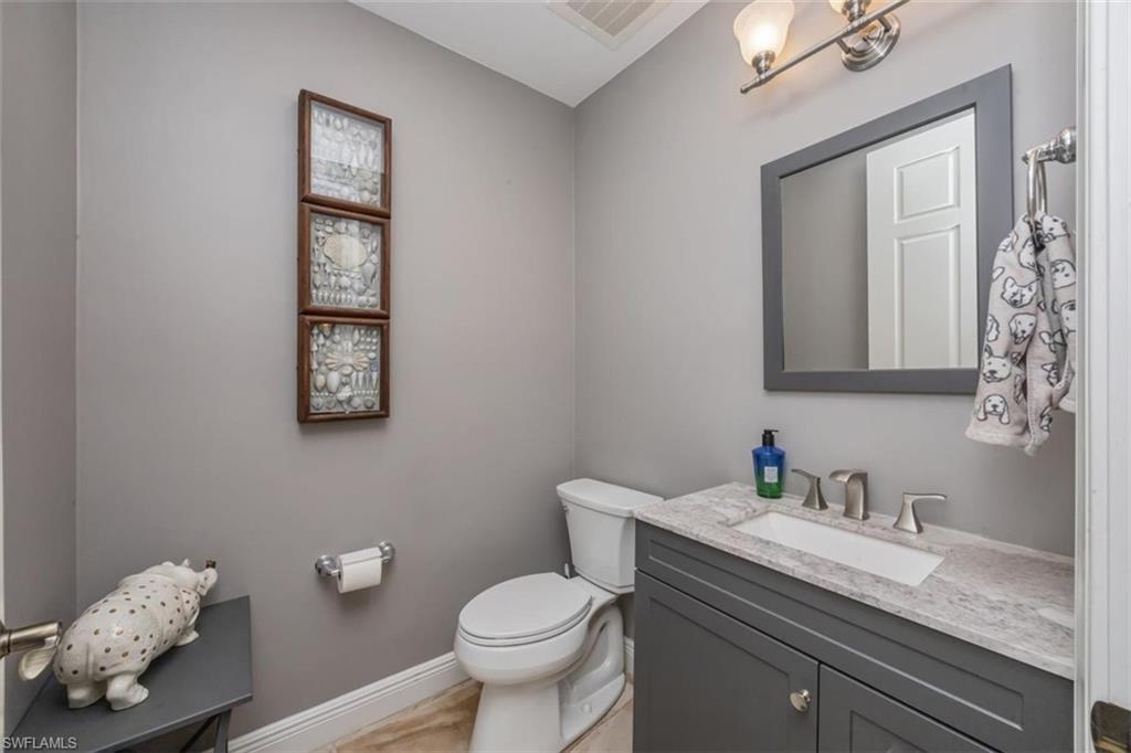 1180 Clam Court Naples, FL 34102 - Photo 11 of 38 a bathroom with a granite countertop sink mirror and toilet