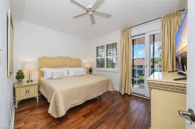 a bedroom with a bed and large windows