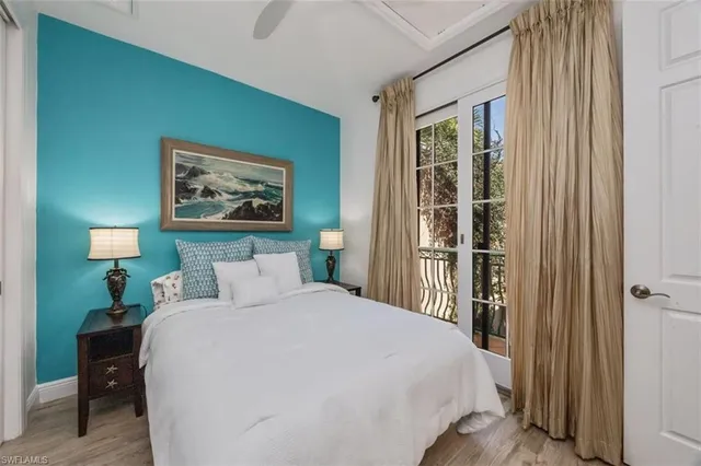 a bedroom with a bed and a painting on the wall