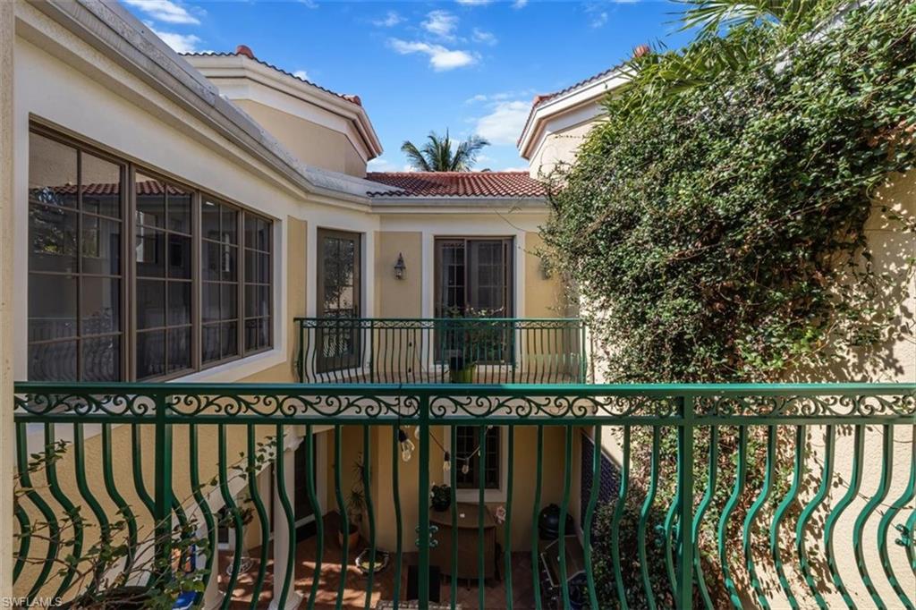 1180 Clam Court Naples, FL 34102 - Photo 21 of 38 a front view of a house with a garden