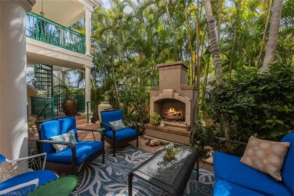 a backyard of a house with outdoor seating