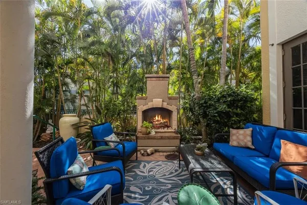 a outdoor living space with furniture and a fireplace