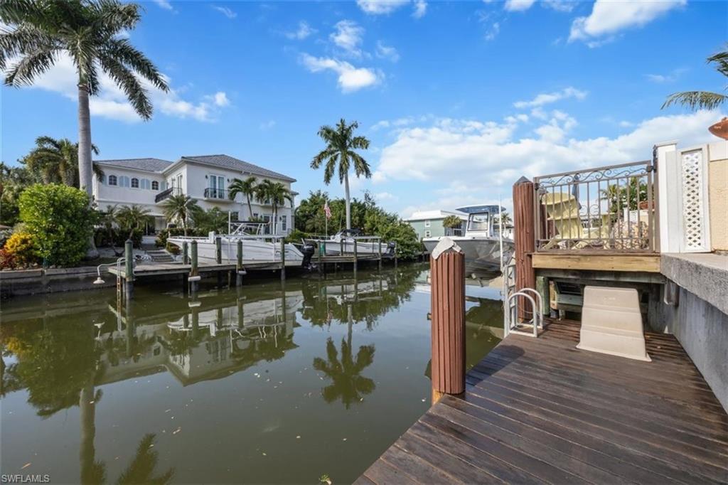 1180 Clam Court Naples, FL 34102 - Photo 33 of 38 a view of a lake with a table and chairs