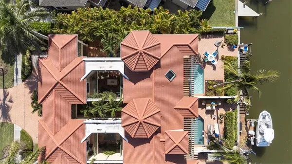 an aerial view of a house with a yard and potted plants