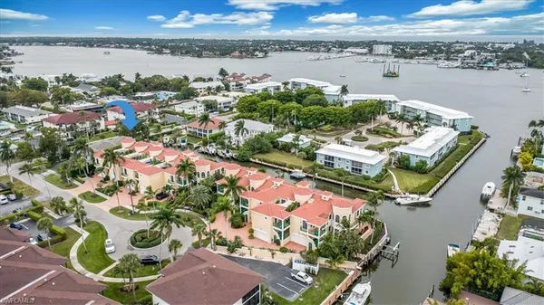 an aerial view of lake and residential houses with outdoor space