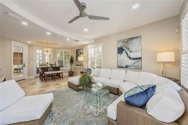 a living room with furniture and view of kitchen