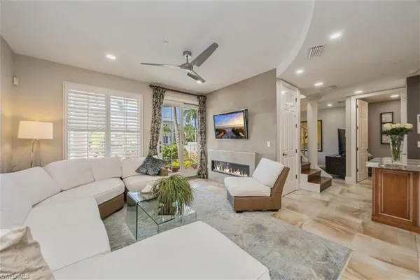 a living room with furniture and large windows
