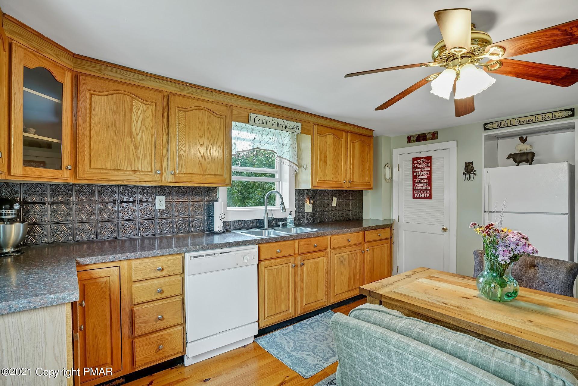 1186 Burger Hollow Road Effort, PA 18330 - Photo 13 of 35 a kitchen with kitchen island granite countertop a sink cabinets stainless steel appliances and a window