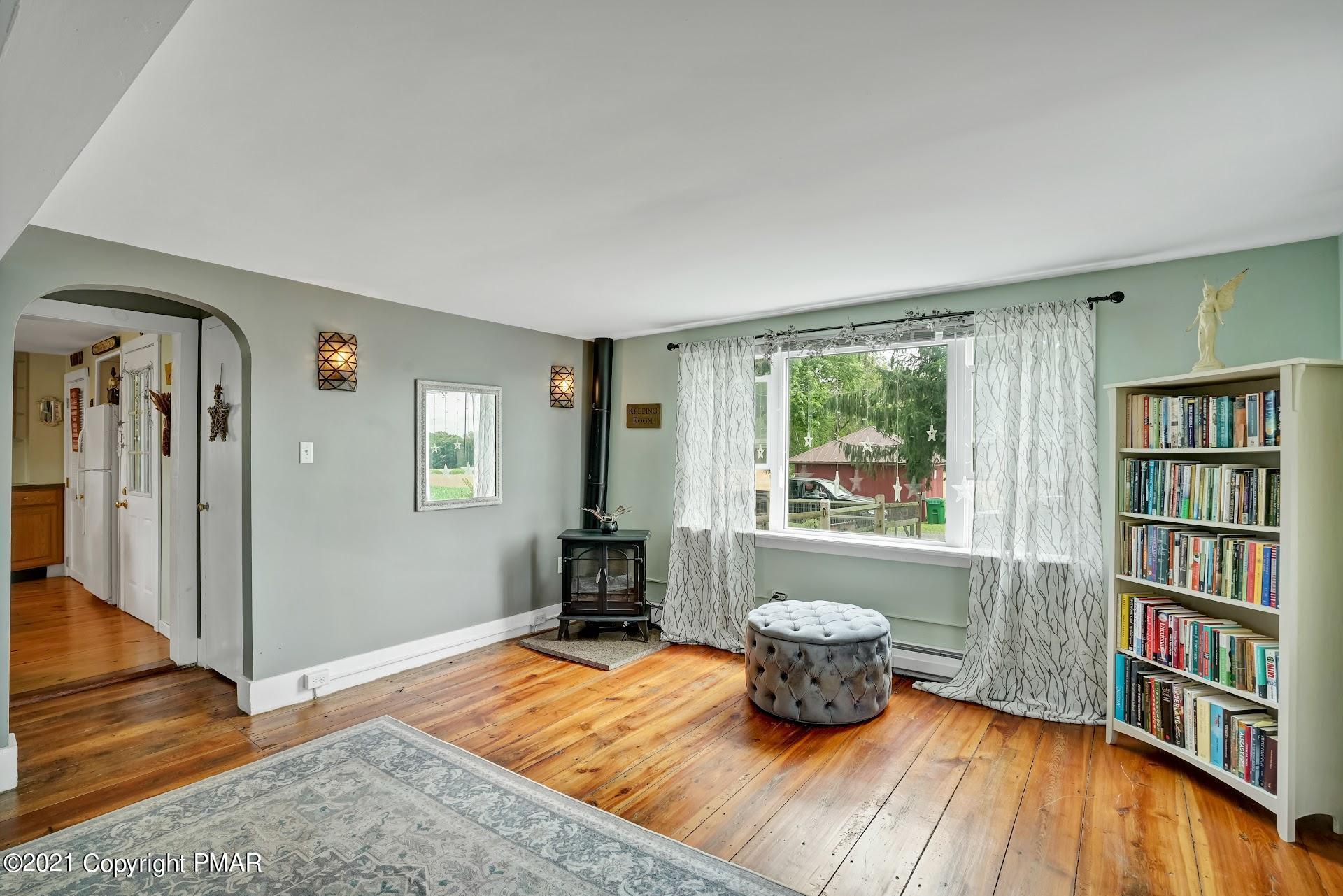 1186 Burger Hollow Road Effort, PA 18330 - Photo 15 of 35 a living room with a couch and a book shelf