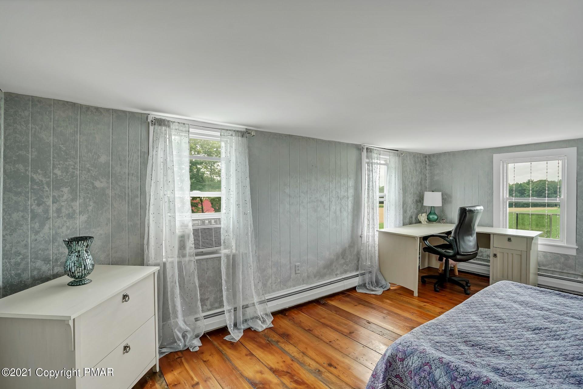 1186 Burger Hollow Road Effort, PA 18330 - Photo 18 of 35 a bedroom with furniture and a wooden floor