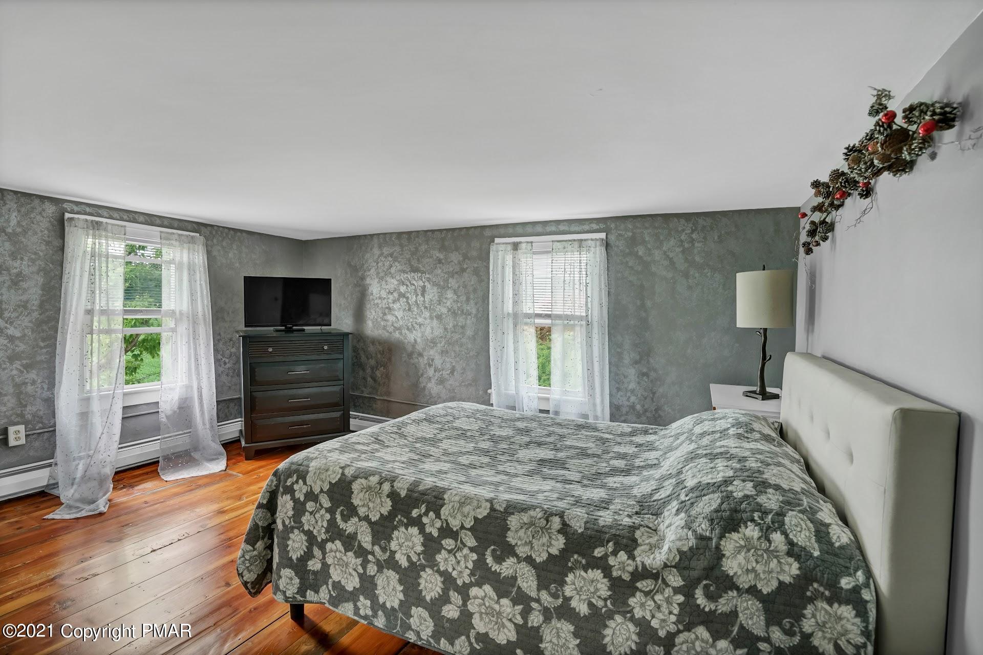 1186 Burger Hollow Road Effort, PA 18330 - Photo 19 of 35 a bedroom with a bed and a television