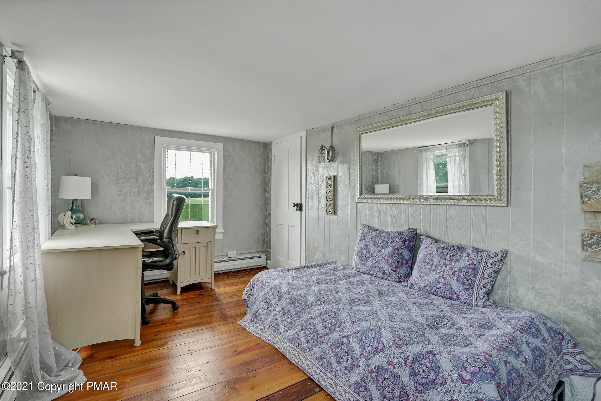 1186 Burger Hollow Road Effort, PA 18330 - Photo 21 of 35 a bedroom with a bed and a wooden floor