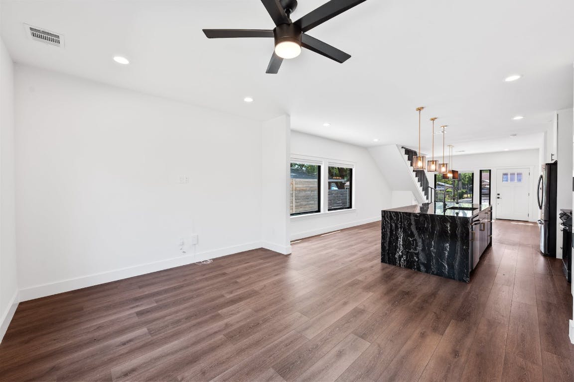 7008 Meador Avenue, Unit 1 Austin, TX 78752 - Photo 11 of 28 a view of a room with wooden floor and ceiling fan