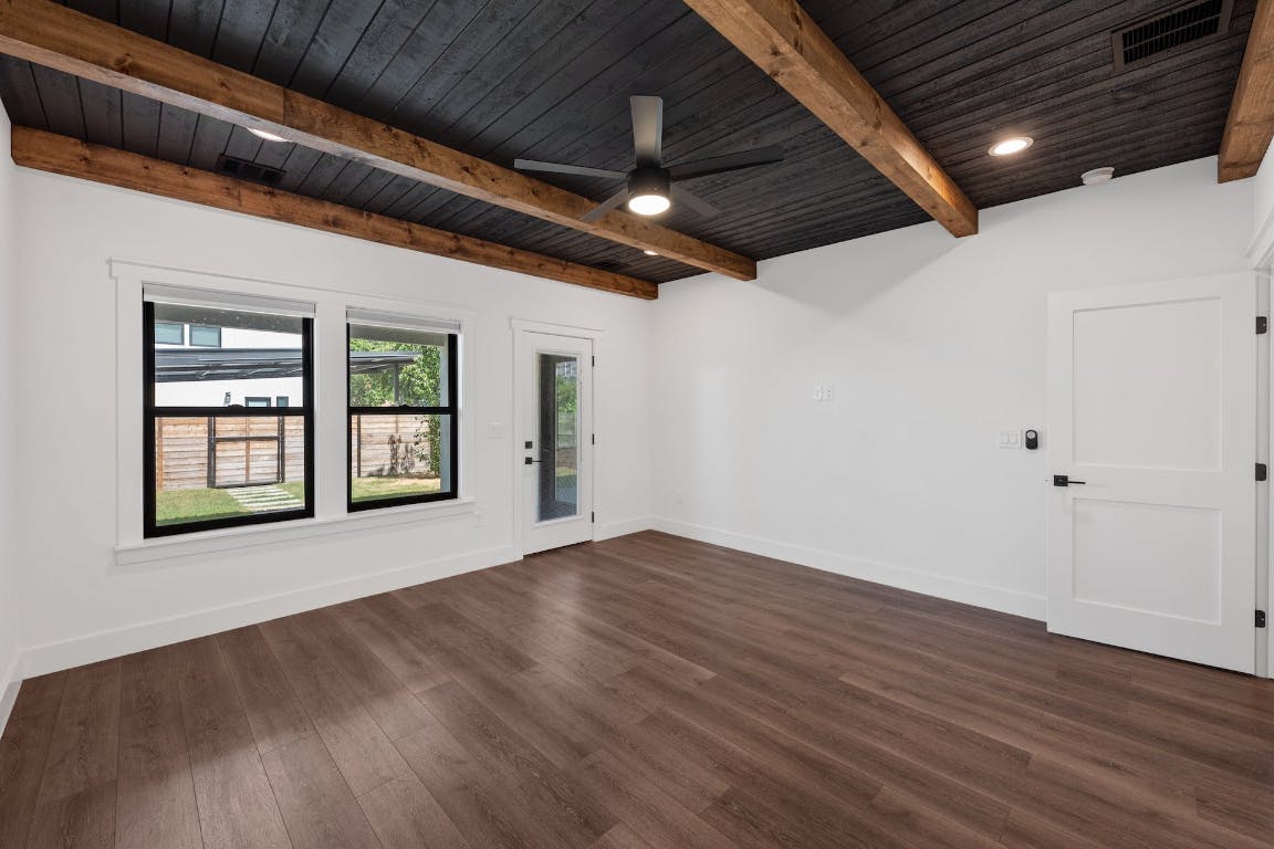 7008 Meador Avenue, Unit 1 Austin, TX 78752 - Photo 13 of 28 a view of an empty room with wooden floor and a window