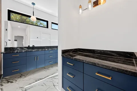 a kitchen with granite countertop cabinets and window