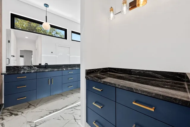 a kitchen with granite countertop cabinets and window